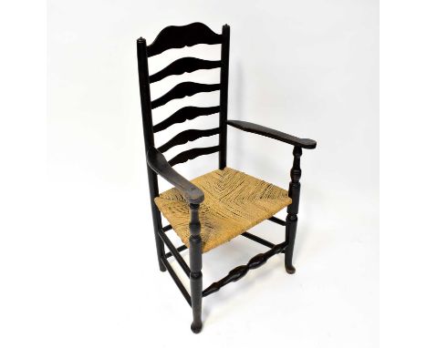 A 19th century ladder back armchair with rush seat.