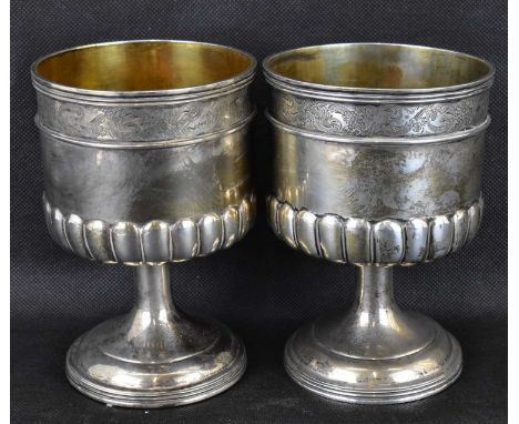 A pair of late 19th/early 20th century gilt white metal wine goblets of Renaissance style, probably Continental with a border