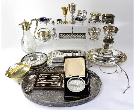 A quantity of silver plated ware to include an engraved ewer, a galleried tray, a table clock, various bowls, blue glass line