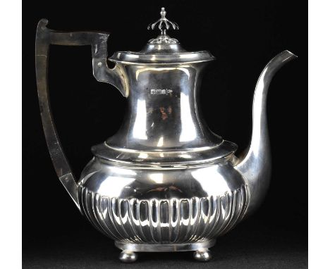 An Edwardian hallmarked silver teapot with ebonised handles and knop, Walker &amp; Hall, Sheffield 1901, height 24cm, approx.