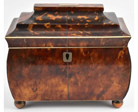 A George III tortoise shell veneered tea caddy of sarcophagus form, silver panel to the top and escutcheon, two-section foil 