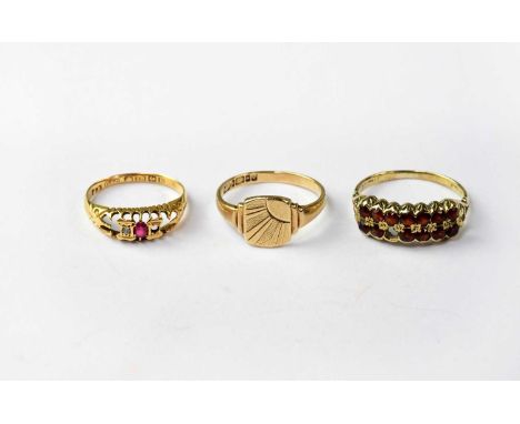 A 9ct yellow gold signet ring, a 9ct yellow gold dress ring set with small garnets (af), combined approx. 4.5g, and an 18ct y