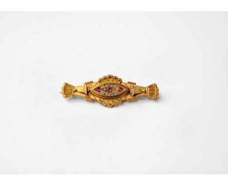 A Victorian 9ct yellow gold bar brooch set with three small rubies, the central ruby in starburst setting with tiny seed pear