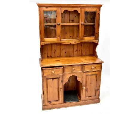 A reproduction pine dog kennel dresser, the upper section with boarded two-shelf plate rack with two glazed panel doors, abov