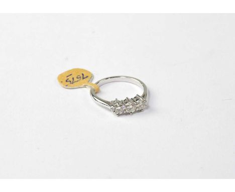 An 18ct white gold ring set with three diamonds, stamped 18ct, size O1/2, approx. 3.7g.Condition Report: Each stone approx. 0