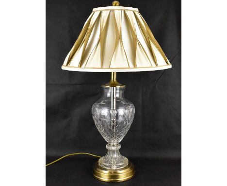 A 20th century cut glass bodied lamp of baluster form, cut with fans and cross-hatching, on an antique finish circular base, 