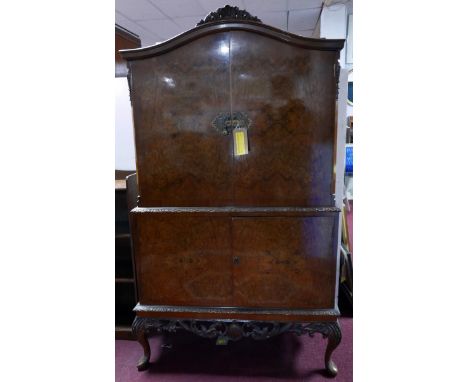 A mid 20th century burr walnut drinks cabinet with well fitted and mirrored interior, makers label, A Gold Feather Product. H