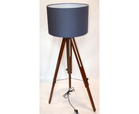 An adjustable tripod standard lamp with shade 