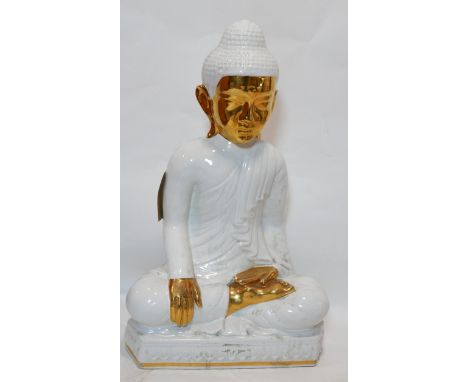 A large white and gold ceramic model of a seated Buddha, H.79 W.48 D.32cm 