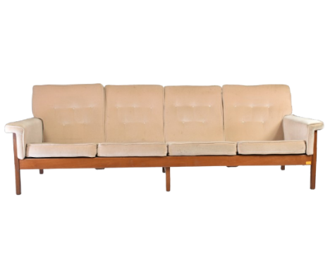 Guy Rogers - A retro 20th century British design teak framed four seater sofa settee. The sofa with salmon coloured button ba