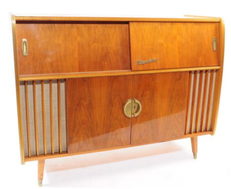 A mid century Rigoletto walnut cased radiogram. Shaped body with inset record deck and radio, with drinks cabinet to undersid