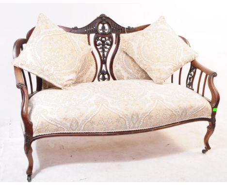 An early 20th century Edwardian Art Nouveau ebonised walnut settee love seat. The chair raised on carved cabriole legs over c