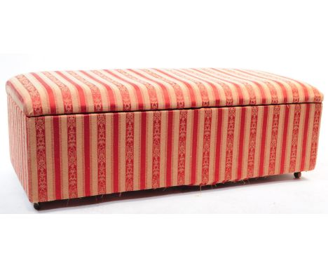 A vintage mid century ottoman / blanket box. Having a cushioned rectangular top on a hinged lid opening to reveal spacious in