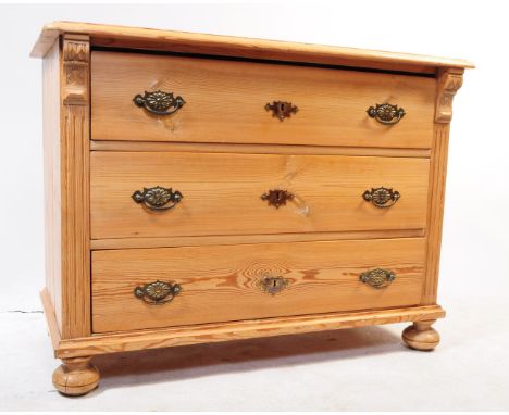 An early 20th century pine commode chest of drawers. The commode having a bank of three drawers to the front, each with brass
