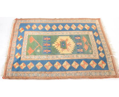 A vintage 20th century Turkman carpet floor rug. Rectangular form with character to central panel with fig leaves, with repea