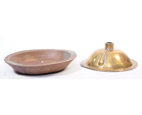A 19th century brass washbasin sink alongside a wooden dough trough bowl. The bowl reinforced with metal cladding. The washba