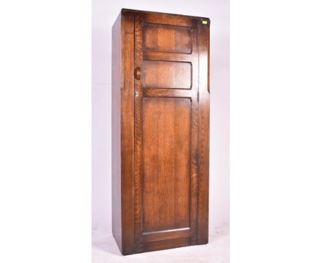 A vintage 20th century circa 1940s panel oak wardrobe / hall cupboard. Full length door with shelved interior. Supported on a