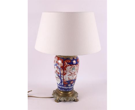 A porcelain Imari lamp base with bronze base and frame, Japan, Meiji, circa 1900, h 40 cm.