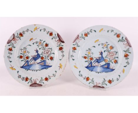 A pair of polychrome Delftware plates, Holland, 18th century. Chinoise decor bird at a pond and flora, Ø 23 cm, tot. 2x.