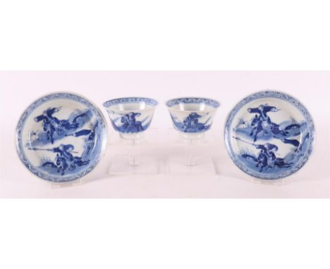 A pair of blue and white porcelain cups and saucers, China, 18th century. Blue underglaze decoration of hunting scene, marked