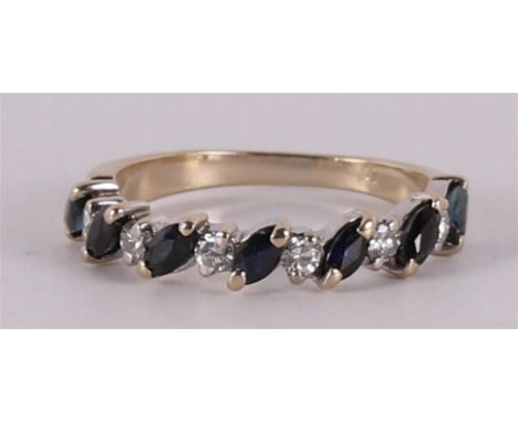 An 18 kt 750/1000 gold row ring with 7 marquise cut blue sapphires and 6 brilliants of 0.05 crt each. Total 0.30 crt H-VS. Ri