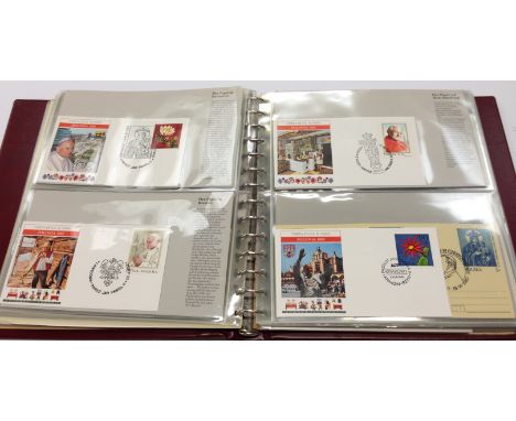 An expensive album in folder containing a collection of Papal World First Day Covers, mainly relating to John Paul II.
