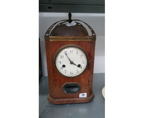 An early 20th century Arts & Crafts style square oak cased mantle clock with metal dome bell top.
