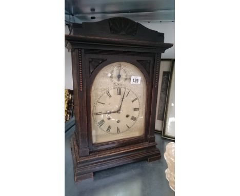 An oak cased bracket clock.