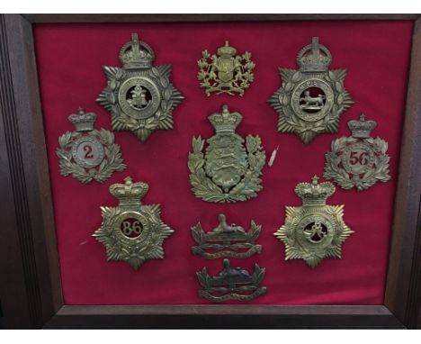 A framed display of various Victorian and other brass Military helmet plates.
(R59)