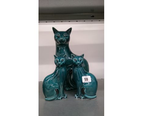 A large Poole Pottery blue glazed Vogue Cat together with a pair of smaller Cats.