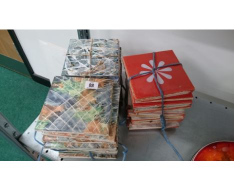 A collection of various hand painted tiles decorated by Phyliss Butler Poole Pottery tile paintress.