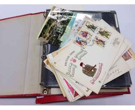 Two albums containing a quantity of various First Day Covers and Mint and unused stamp sets.