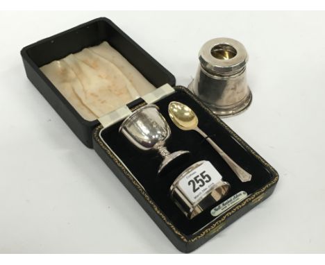 A silver Christening set comprising egg cup, serviette ring and spoon in original presentation case together with a silver in