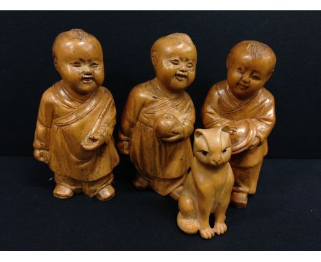 Three carved fruitwood miniature Chinese figures modelled as Children Holding Different Objects together with a Netsuke model