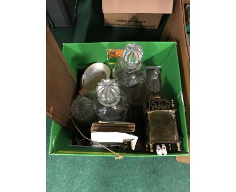 A pair of cut glass decanters together with a brass Smiths electric lantern clock and other items.