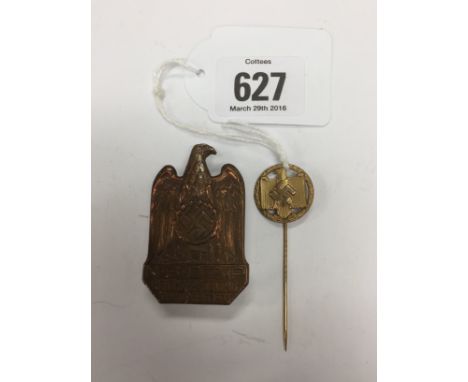 A 1942 gilt NSRL achievement stick pin together with a German Rally NSDAP Parteitag 1933 badge.
