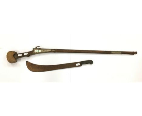 A horn handled machete together with an Arabian Arab Matchlock musket (both af).