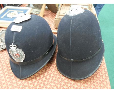 Two Berkshire Constabulary Police helmets together with a silver mounted walking stick.
