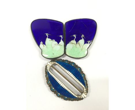 A Marius Hammer silver and enamel buckle together with a Japanese enamel buckle.
(R5)