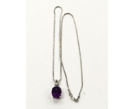 A 9 carat white gold amethyst and diamond set pendant and chain.