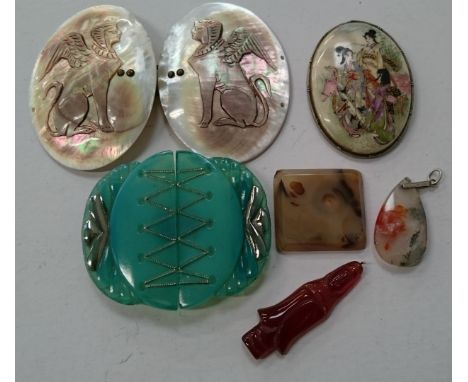 A Cameo carved mother of pearl buckle decorated with a Winged Egyptian God together with a green jade coloured buckle and oth