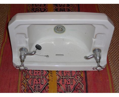 Cloaks room porcelain wash hand basin and swing mirror in the Art Deco style