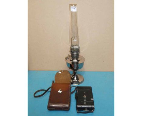 A 1902 Tylar and England five roll folding film and plate camera and a chrome plated oil lamp
