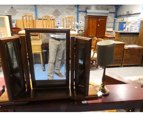 A freestanding toilet mirror and mahogany table lamp