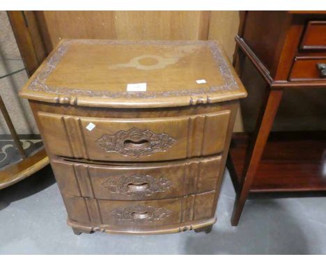 A small bow front carved chest of drawers