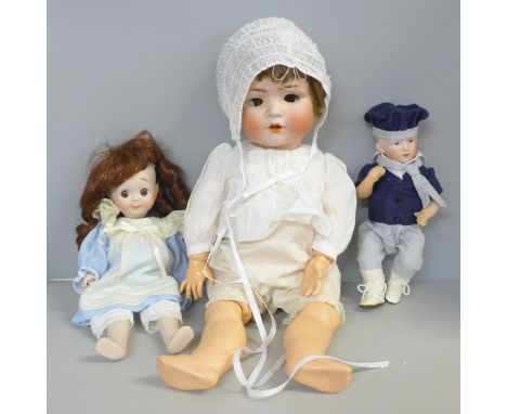 A reproduction J.D. Kestner 221 bisque doll, signed Barbara Hamm 1986, a German bisque head sailor boy doll, a BP German bisq