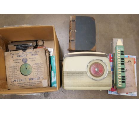 A box of assorted items including plated ware, 78rpm records, a Bush radio, a Hohner Melodica, etc. **PLEASE NOTE THIS LOT IS