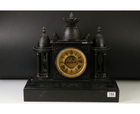 19th Century slate mantle clock with Roman numerals on a brass dial, flanked by two four-column architectural structures hous
