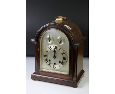 Edwardian mahogany chiming mantle clock with arched silvered dial, poker-style hands, slow/fast and chime/silent subsidiary d