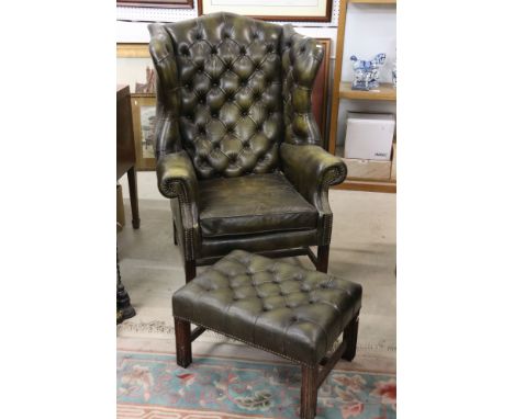 Green Leather Button Back Wing Back Armchair in the George III manner 83cm wide x 120cm high together with a matching footsto